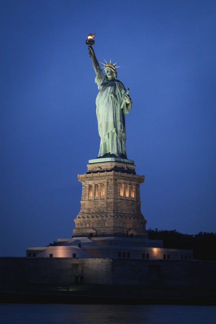 Stunning nighttime view of the Statue of Liberty on Liberty Island, New York City.